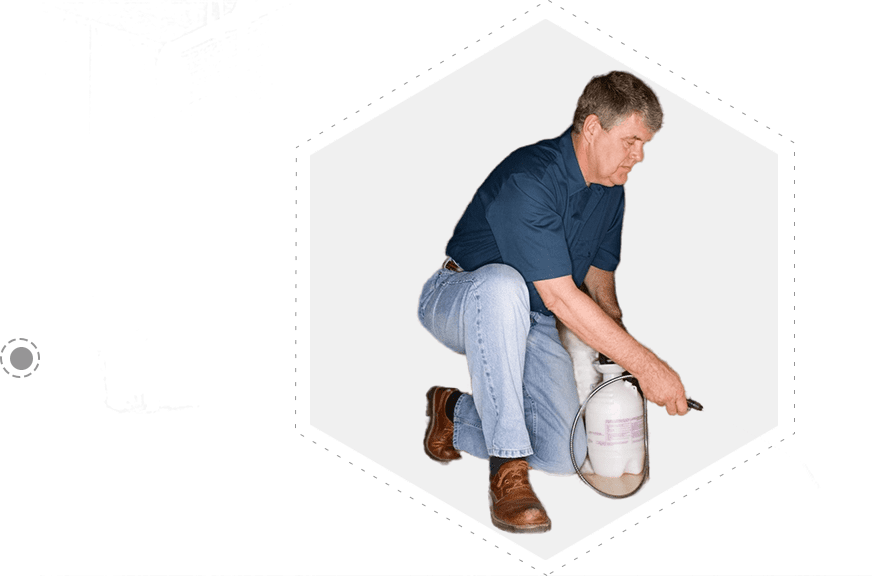 A man kneeling down holding an oxygen tank.